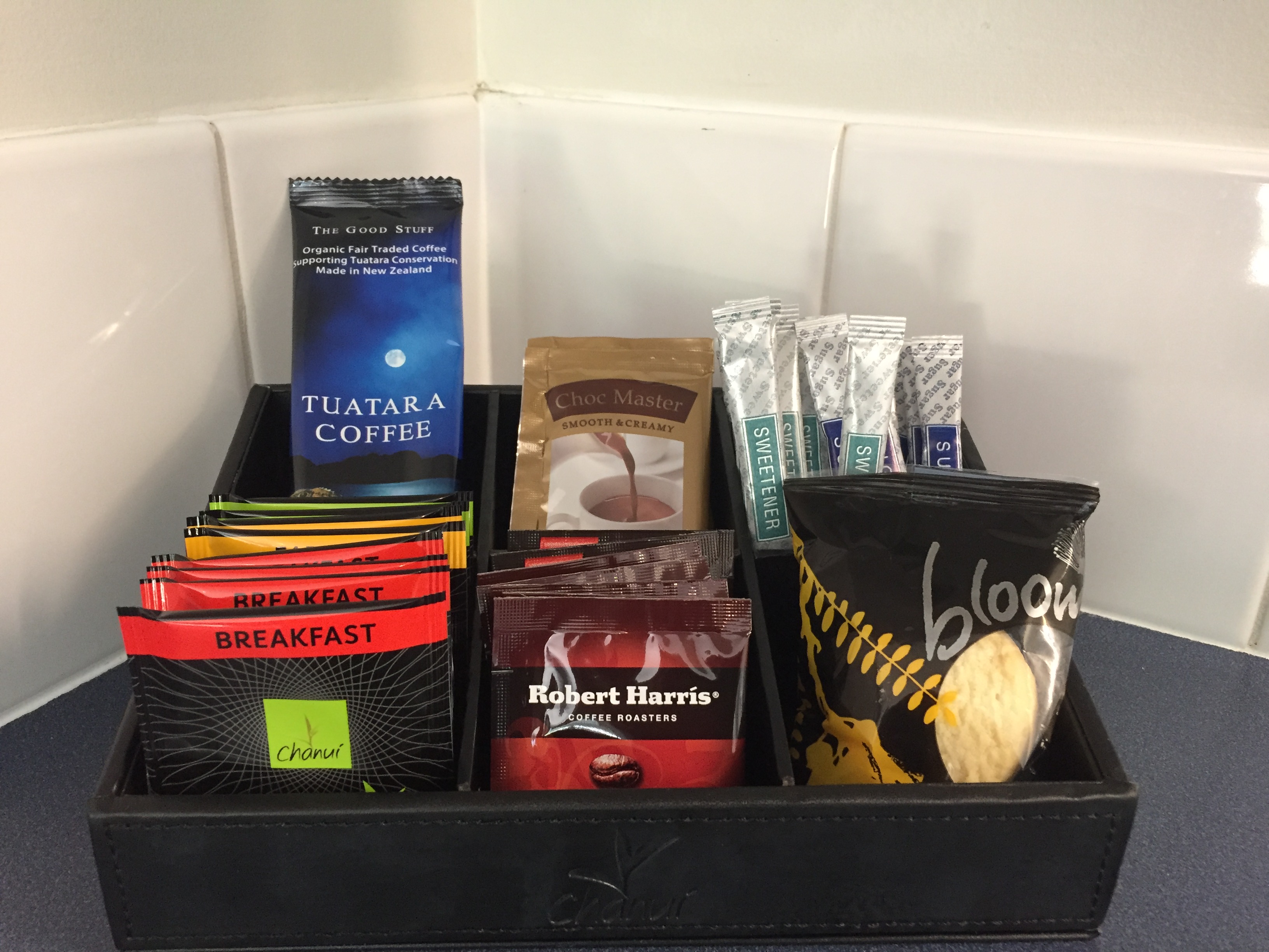 Tuatara Coffee plunger sachet presented with in-room guest refreshments.